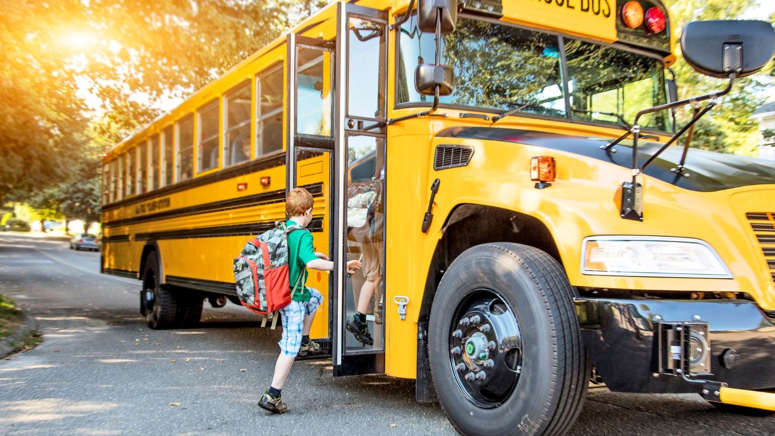 Students getting onto a school bus.